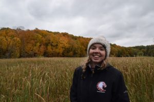 Augsburg student Grace smiling in a field